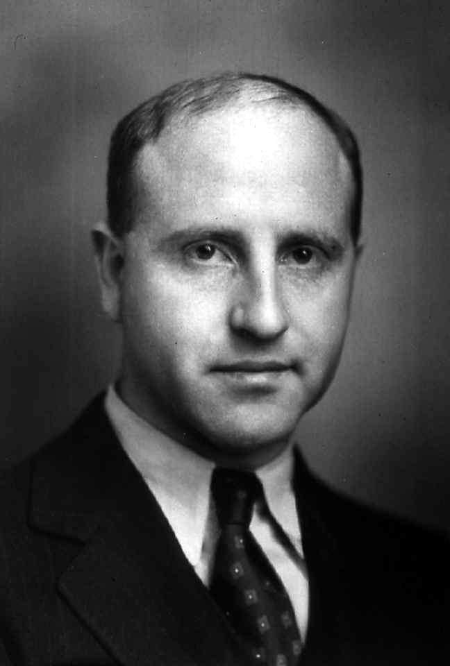 black and white photographic portrait of a mid-century man in a suit.