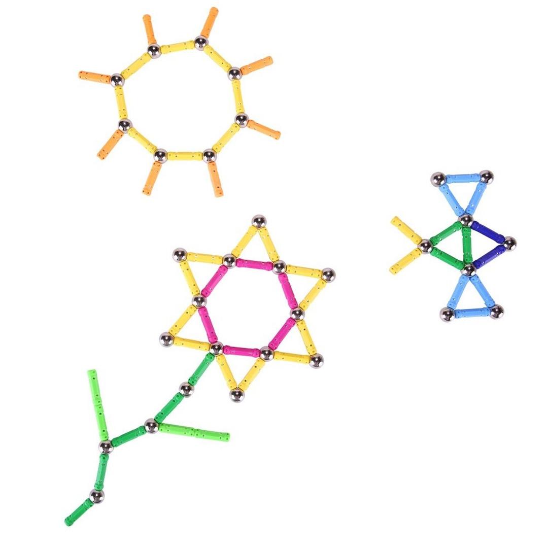 Children's building toy of steel balls and magnetic plastic rods. They have been arranged into the crude shape of a flower, a sun, and a bird in flight.