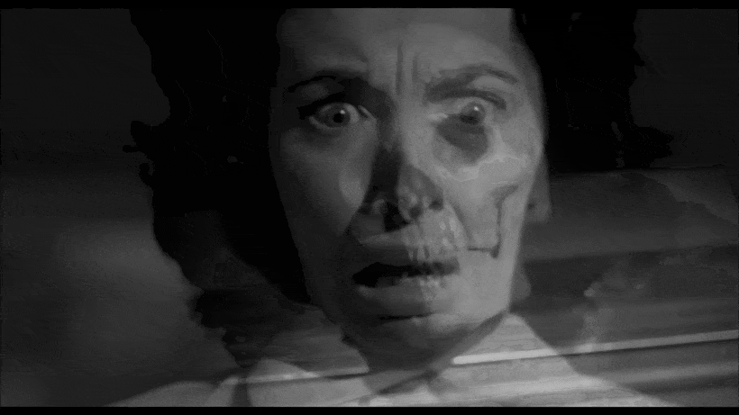 Clip from a black and white movie. A woman sees a skull on the ground then screams and runs away. The skull rolls after her as she faints from fear.