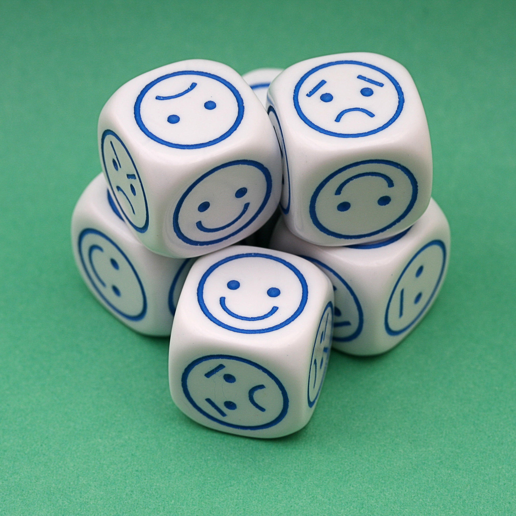 A stack of dice, but instead of numbers they all have smiley faces with different expressions