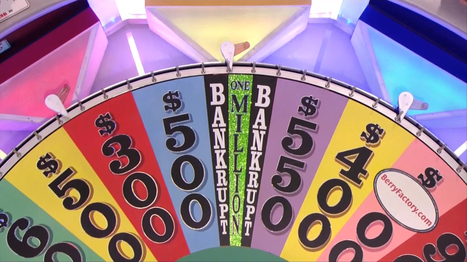 Close up of the wheel from Wheel of Fortune with the spinner landing between two 'Bankrupt' slots to point to the 'One Million' slot